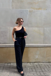 a lady wears a black loose fit pants with black top